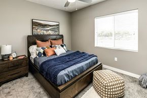 Lincoln apartment for rent - A bedroom with a large bed and a painting on the wall.