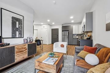 Allentown apartment for rent - A modern living room with a grey couch and a wooden coffee table.