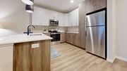 Easton apartment for rent - A modern kitchen with a stainless steel refrigerator and wooden cabinets.
