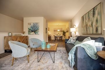 Macungie apartment for rent - A living room with a grey couch and a wooden coffee table.