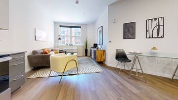 Allentown apartment for rent - A living room with a yellow chair and a brown couch.