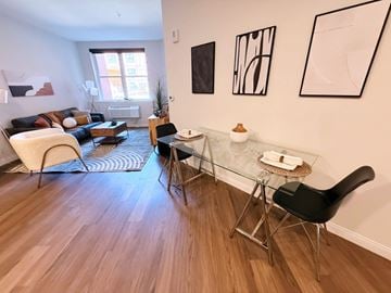 Allentown apartment for rent - A living room with a glass table and a black chair.