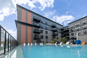 Easton apartment for rent - A swimming pool in front of a modern building with a clear blue sky above.