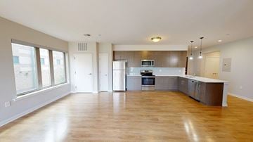 Allentown apartment for rent - A spacious kitchen with wooden floors and modern appliances.