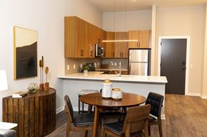 Allentown apartment for rent - A modern kitchen with a wooden table and chairs. at The Hive Apartments, Allentown, Pennsylvania