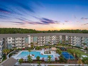 Wesley Chapel apartment for rent - A large apartment complex with a pool and tennis court.