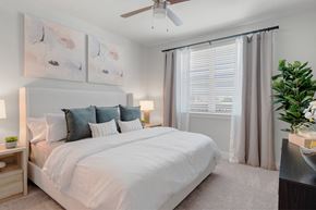 Glendale apartment for rent - a bedroom with a large white bed and a ceiling fan