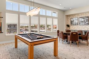 Chandler apartment for rent - a billiards table in a clubhouse with a dining table and chairs