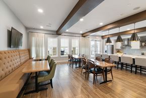 Mckinney apartment for rent - A modern dining room with a wooden table and chairs.