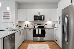Chandler apartment for rent - a kitchen with white cabinets and stainless steel appliances