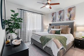 Chandler apartment for rent - a bedroom with a large bed and a ceiling fan
