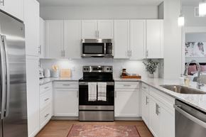Mesa apartment for rent - a white kitchen with stainless steel appliances and white cabinets