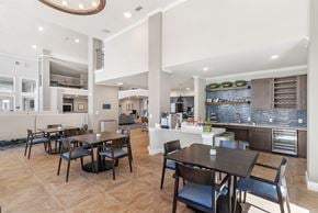 San Antonio apartment for rent - a communal clubhouse dining room opening up to a kitchen at a senior apartment community