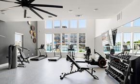 Pflugerville apartment for rent - a gym with lots of weights and a large window