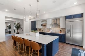 Pflugerville apartment for rent - a blue and white kitchen with stainless steel appliances and a white counter top