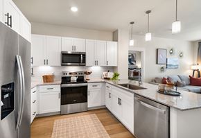 Mesa apartment for rent - A modern kitchen with white cabinets and stainless steel appliances.
