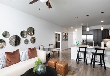 Surprise apartment for rent - a living room with a couch and a kitchen with a bar