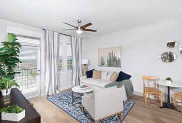 Goodyear apartment for rent - a living room with a couch and a chair and a ceiling fan