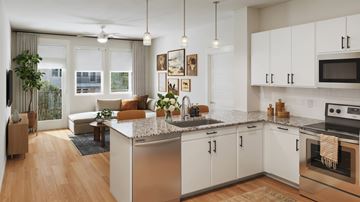 Lawrenceville apartment for rent - A modern kitchen with white cabinets and a large island.