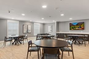 San Antonio apartment for rent - a communal clubhouse dining room with tables and chairs at a senior apartment community