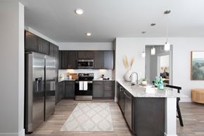 Surprise apartment for rent - a kitchen with stainless steel appliances and a granite counter tops at a senior apartment community