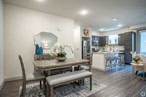 Rowlett apartment for rent - A modern dining room with a wooden table and chairs.