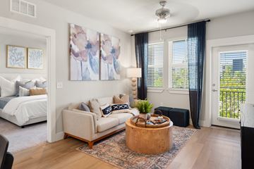 Naples apartment for rent - A living room with a white couch and a large painting on the wall.
