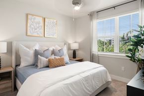 Naples apartment for rent - A bedroom with a large bed and two framed pictures on the wall.