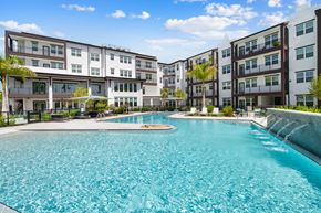 Naples apartment for rent - A large swimming pool in front of apartment buildings.