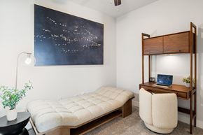 Katy apartment for rent - A bedroom with a bed, desk, and a painting of a night sky.