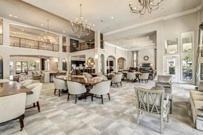 Houston apartment for rent - a communal clubhouse dining room with tables and chairs at a senior apartment community