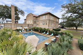 Alexandria apartment for rent - a swimming pool in front of a brick building