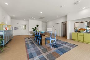 Melbourne apartment for rent - A dining room with a blue rug and chairs.