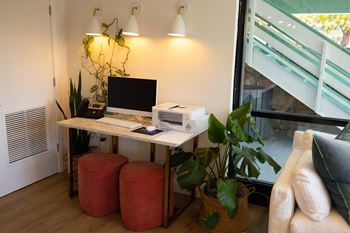 A desk with a computer and a printer on it