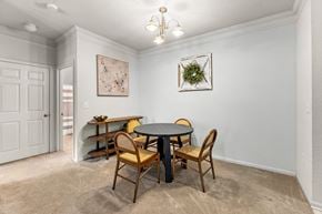 Alexandria apartment for rent - a dining room with a table and chairs and a door