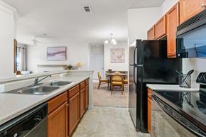 Alexandria apartment for rent - full kitchen with stainless steel appliances and wood cabinets and a dining room with a table