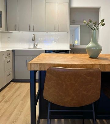 Naples apartment for rent - A kitchen with a wooden table and a brown chair.
