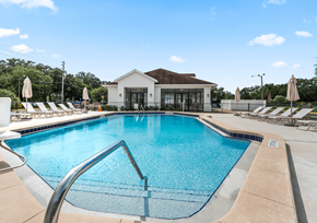 Kissimmee apartment for rent - A large swimming pool in front of a building with a white roof at The Teale Siesta Lago in Kissimmee, FL, 34746