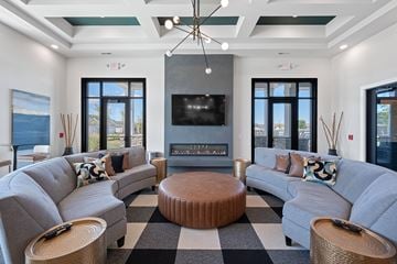 Mason apartment for rent - A modern living room with grey couches and a black and white checkered rug.