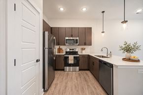 Mason apartment for rent - A modern kitchen with wooden cabinets and stainless steel appliances.