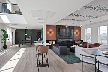 Mason apartment for rent - A modern living room with a fireplace and a television.