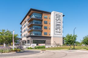 Mason apartment for rent - A multi-story building with a sign that reads "District" on the side.