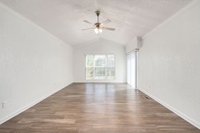 Brighton apartment for rent - A room with a ceiling fan and wooden flooring.