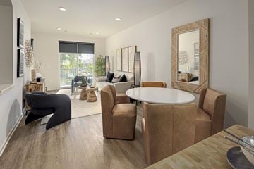 Novi apartment for rent - A modern living room with a round table and chairs.