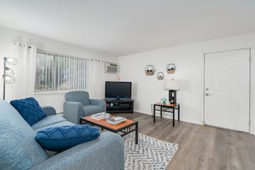 East Lansing apartment for rent - A living room with a grey couch and a coffee table.
