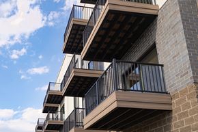 Troy apartment for rent - A building with balconies and railings against a blue sky.