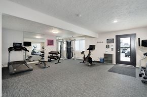 Lansing apartment for rent - A gym with a variety of equipment including treadmills, weights, and exercise bikes.