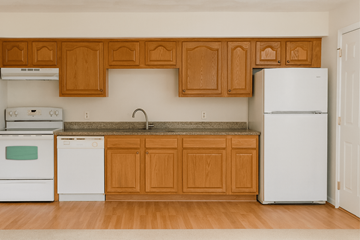 East Lansing apartment for rent - A kitchen with wooden cabinets and white appliances.