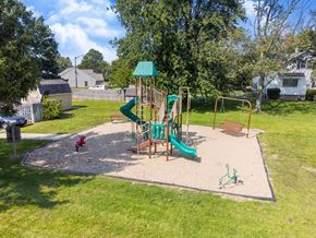 Holland apartment for rent - A playground with a green slide and a red toy car.