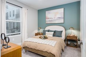 Brighton apartment for rent - A bedroom with a large bed and a painting on the wall.